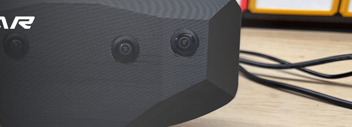 The Vector Gear headset on a workbench, showing its four front-facing cameras.